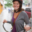 Smiling woman with bicycle and helmet