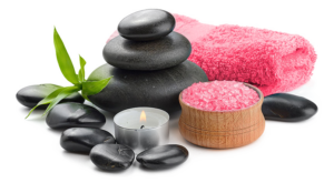 Spa stones, candle, pink towel, bath salt